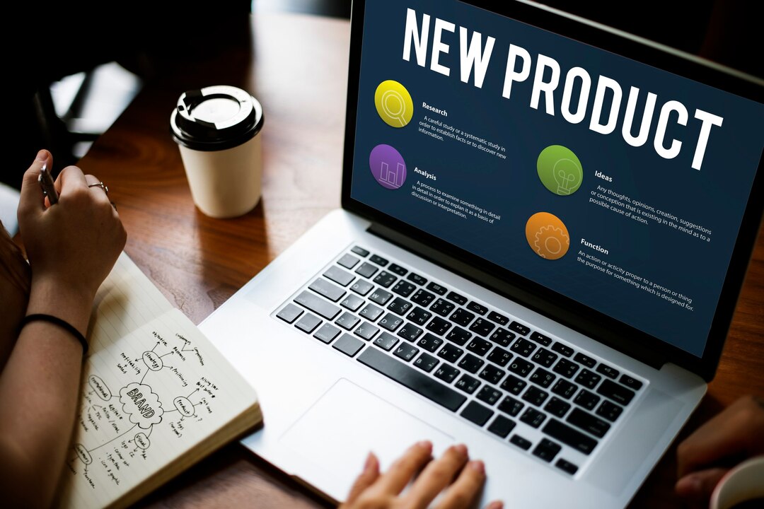 Commercial product development planning on laptop with research and brand strategy notes.