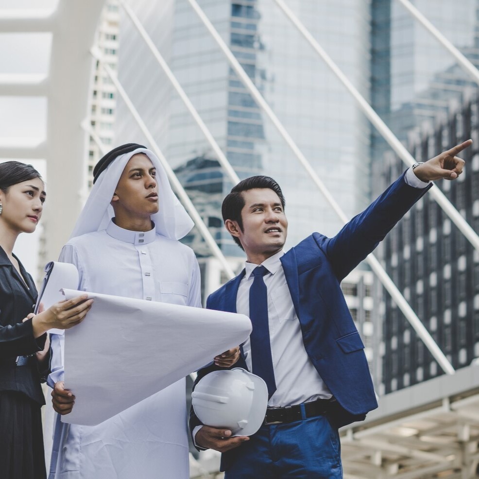 Diverse team of architects and developers planning a new Tourism and Hospitality project in a modern city.