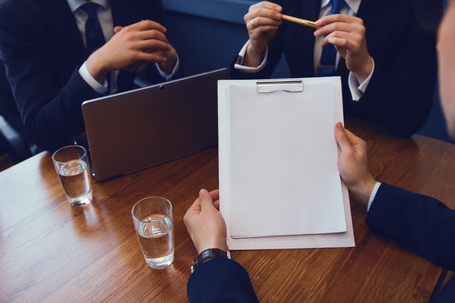 Commercial business meeting with professionals reviewing contract documents.