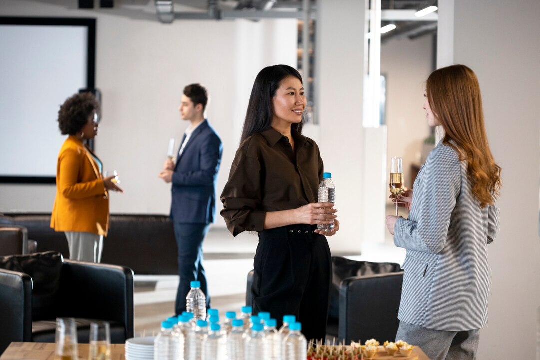 Commercial networking event with professionals engaging in business conversation.
