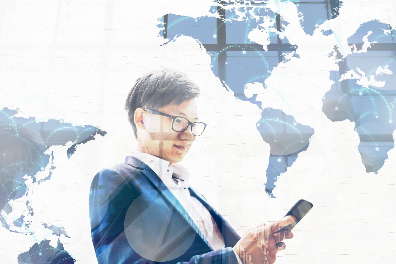 Advisory professional analyzing global business data on mobile for Nuwa Partners strategy solutions.