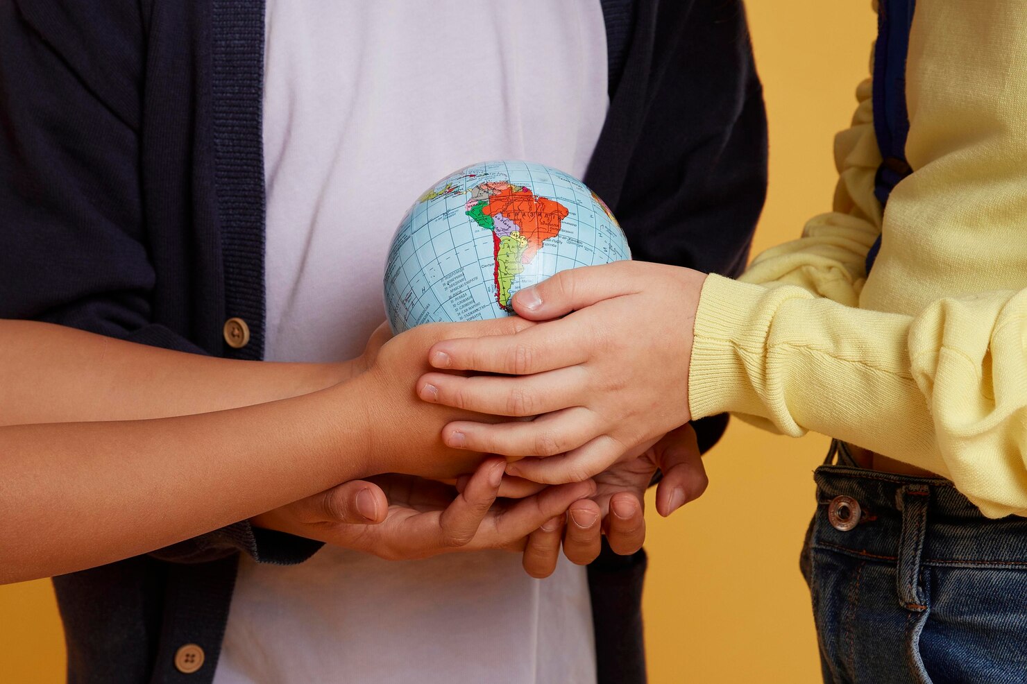 Incubation concept symbolized by hands holding a globe representing global collaboration and innovation.