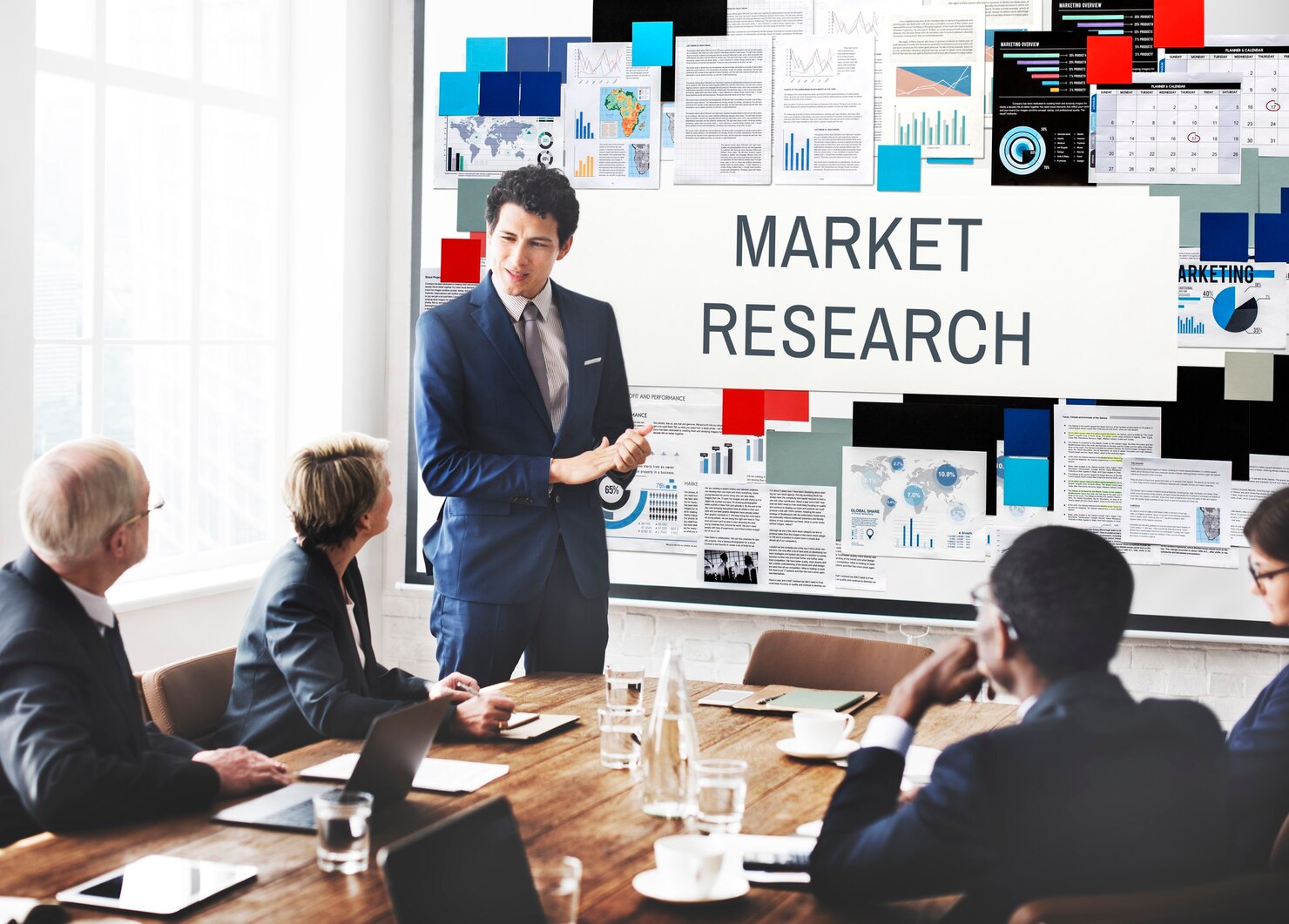 Commercial market research meeting with business professionals analyzing data and strategies.