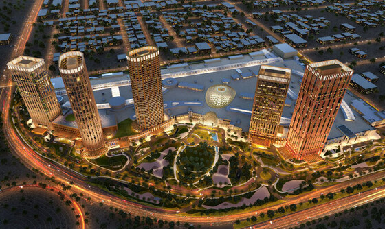 Aerial view of a large, illuminated mixed-use Real Estate & Giga-Projects development with towers, retail, and parkland at dusk.